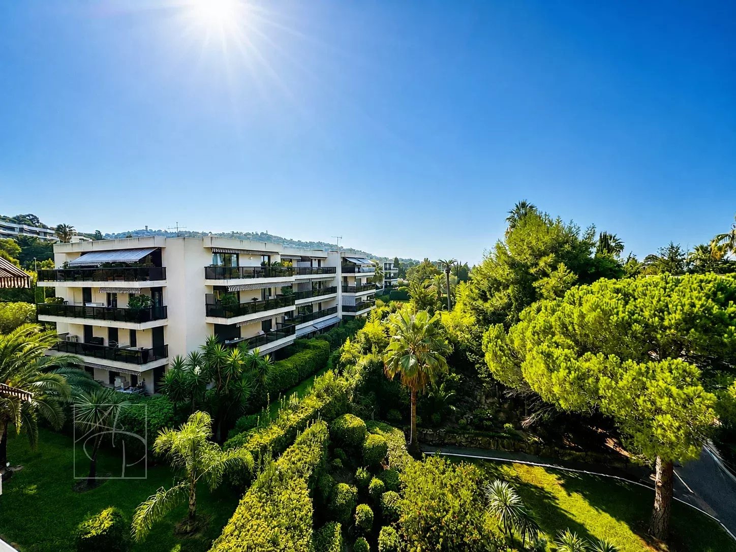 Unobstructed view of a green park and buildings in Cannes from a top floor.