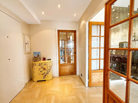Entrance to an apartment with yellow furniture and glass doors, bright and spacious.