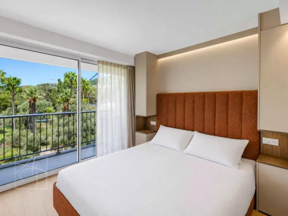 Room in a renovated apartment with balcony and greenery view in Cannes.