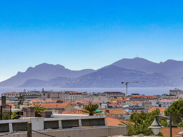 Panoramic view of Cannes and the surrounding mountains from a high-floor apartment.