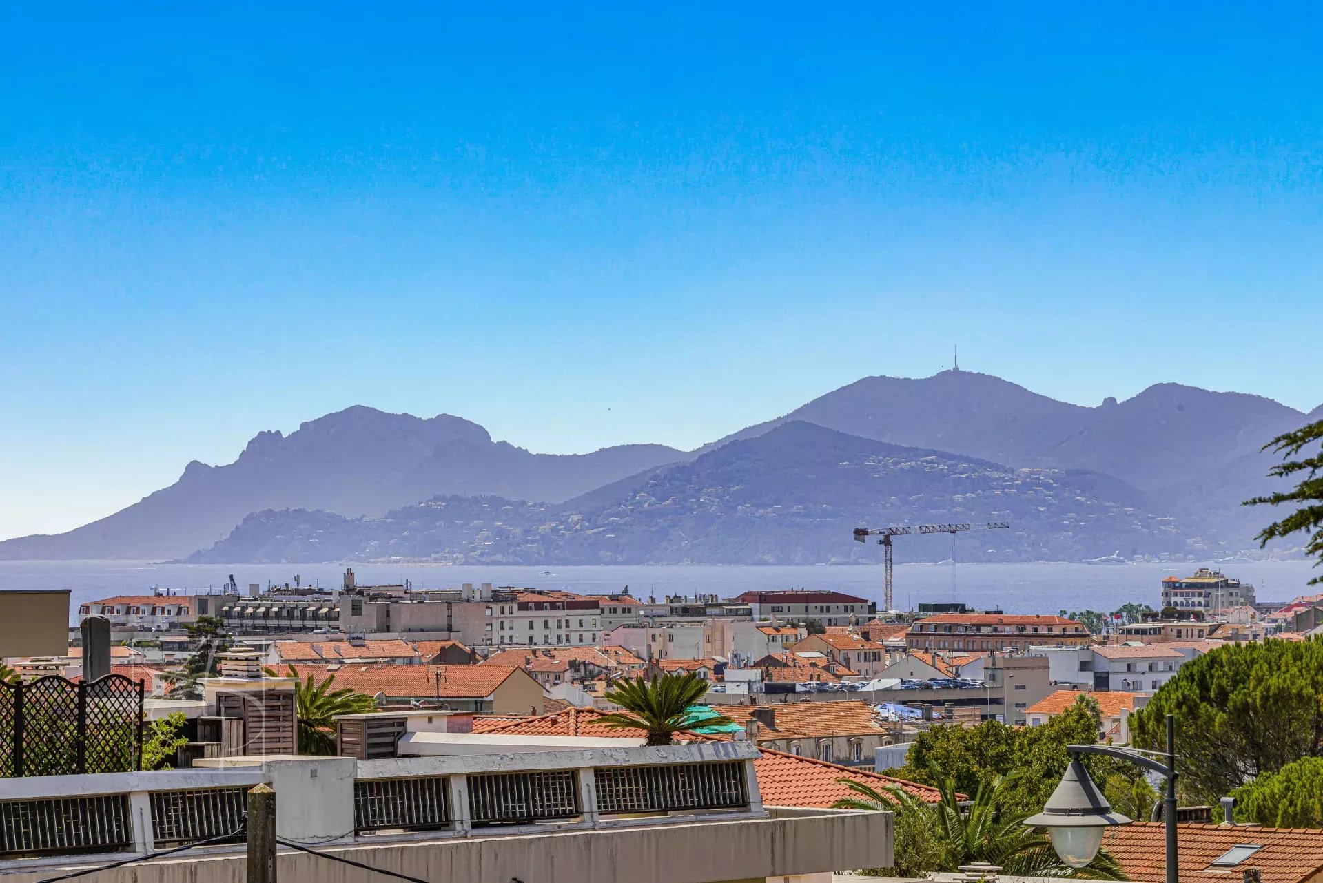 View of Cannes and the mountains Panoramic view of Cannes and the surrounding mountains from a high-floor apartment.
