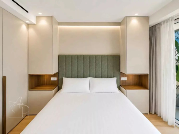 Room in a renovated apartment with a double bed and modern decor.