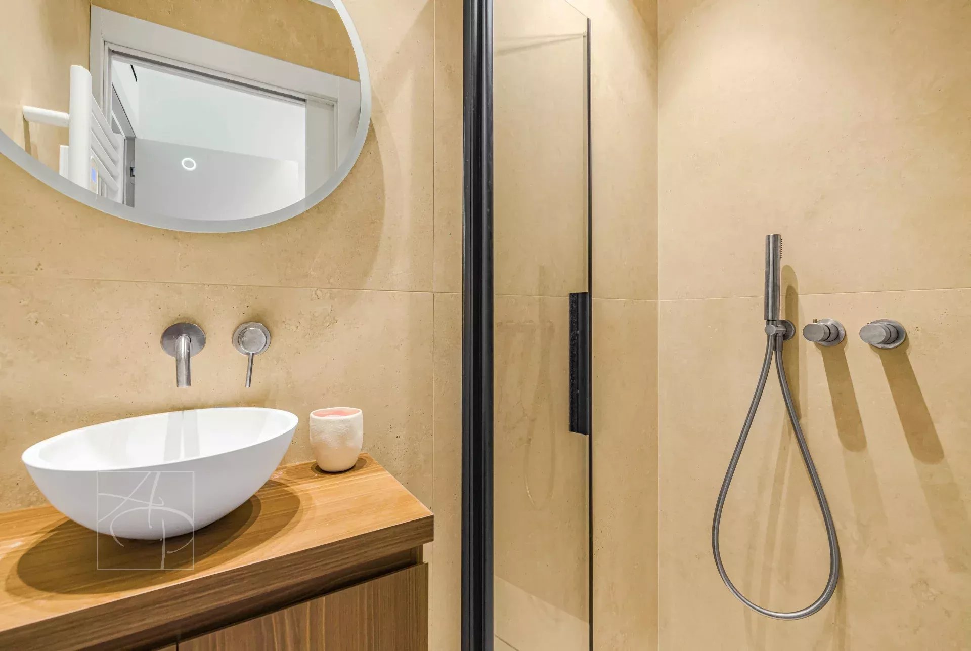 Contemporary bathroom Modern bathroom with shower, washbasin on wooden unit and round mirror.