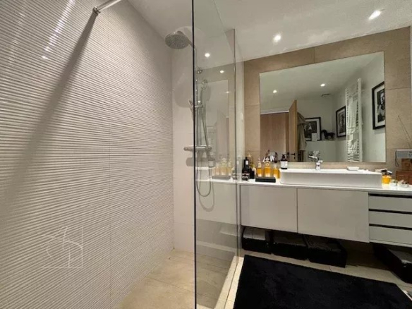 Modern bathroom with walk-in shower and vanity unit