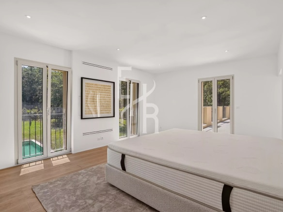 Chambre spacieuse avec fenêtres donnant sur un jardin à Mougins.