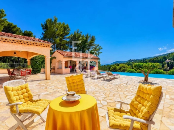 Sunny terrace with yellow chairs and panoramic views of nature in Cabris.