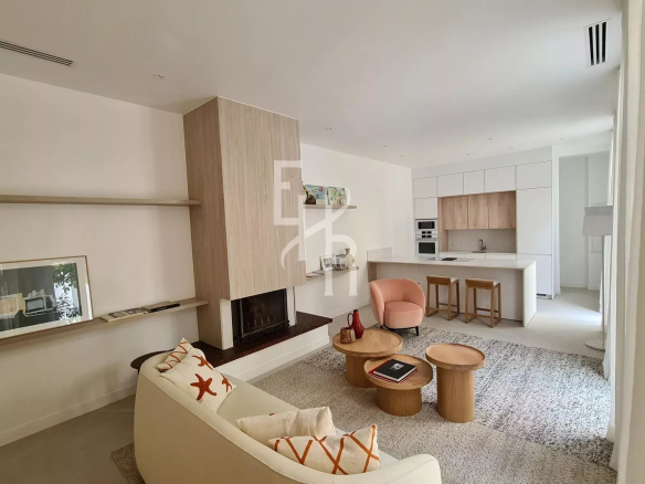 Interior of a townhouse in Cannes with a modern living room and open kitchen.