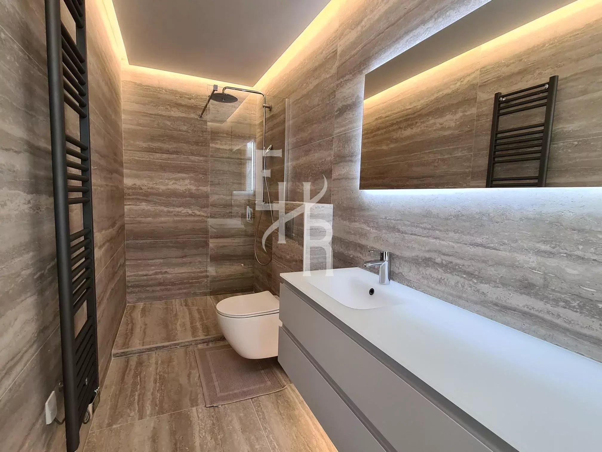 Renovated bathroom in Cannes Modern bathroom with glass shower and marble vanity unit