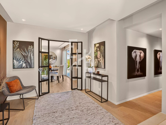 Interior of a modern villa with a bright entrance hall and artwork on the walls.