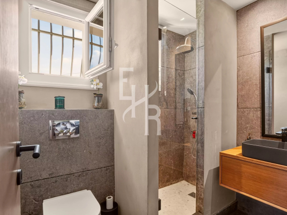 Modern bathroom with glass shower and wooden sink