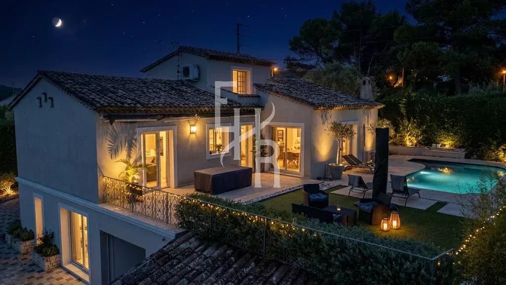 Villa in Mougins with swimming pool Modern villa with swimming pool and views of the hills in Mougins, lit up at night.
