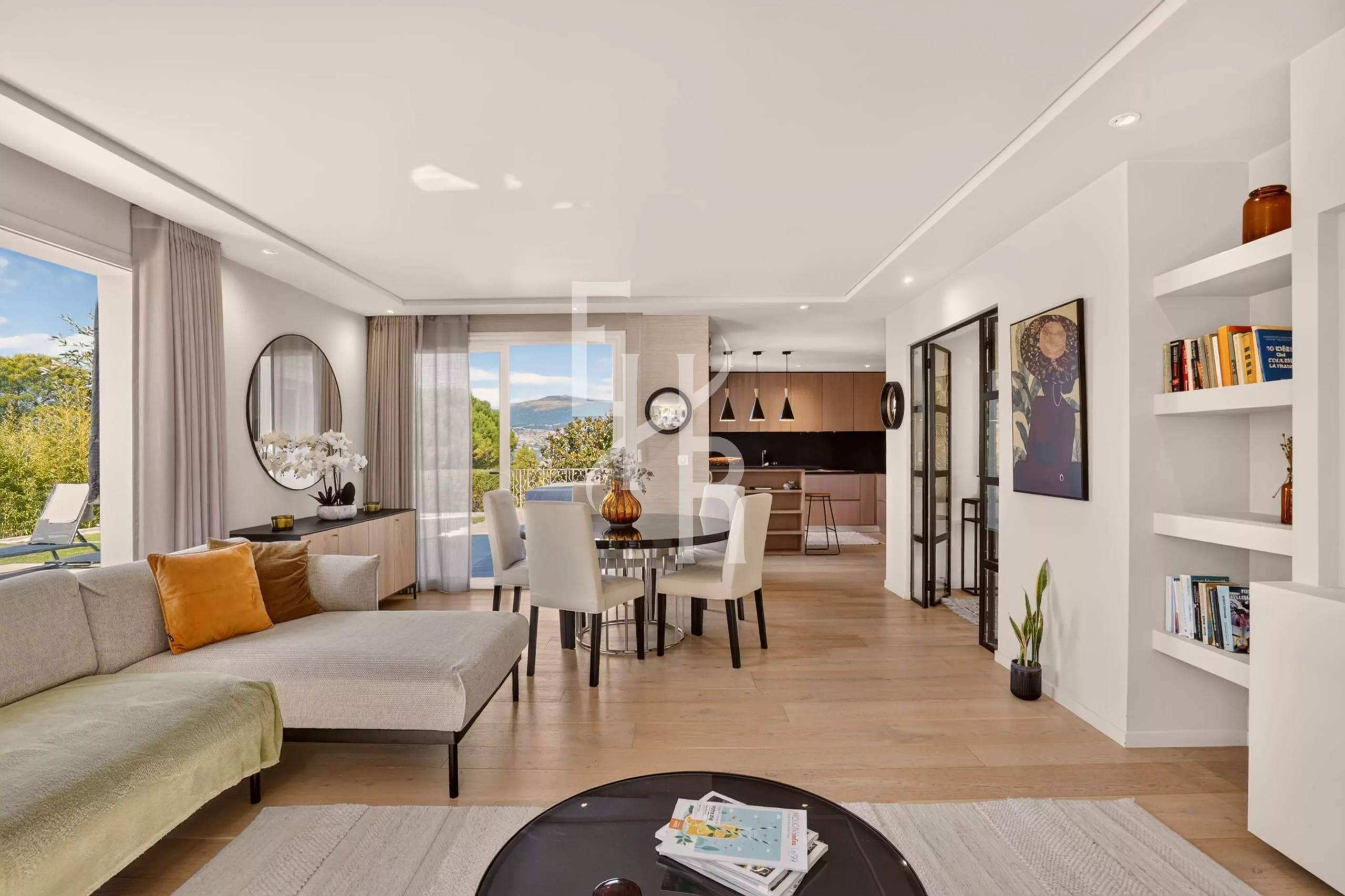Interior of a villa in Mougins Interior of a modern villa with a bright living room and views of nature.