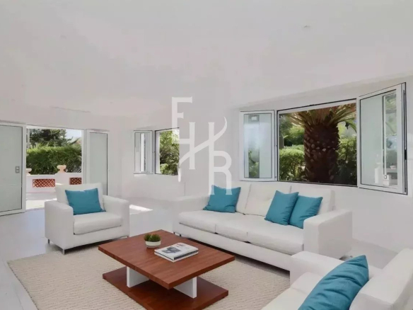 Bright interior of a renovated house with a modern living room and garden view.