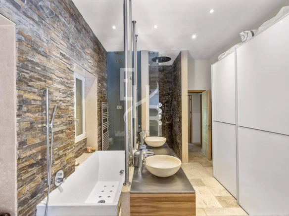 Modern bathroom with bathtub, showers and double stone sink.