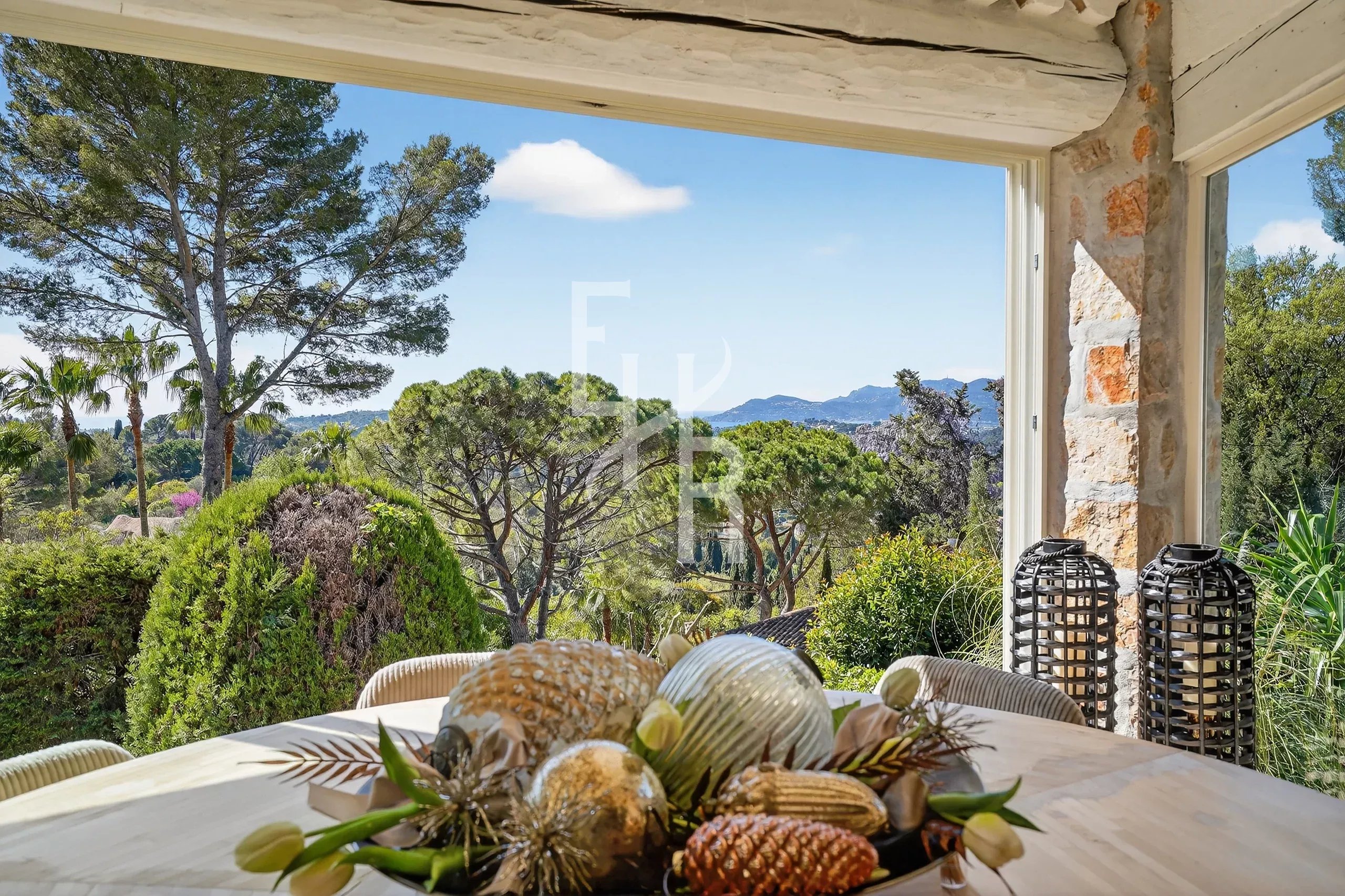 View of the Provençal Villa in Mougins View from a Provençal villa with interior decoration and green landscape in the background.