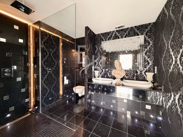Modern bathroom with double sink and elegant decor.