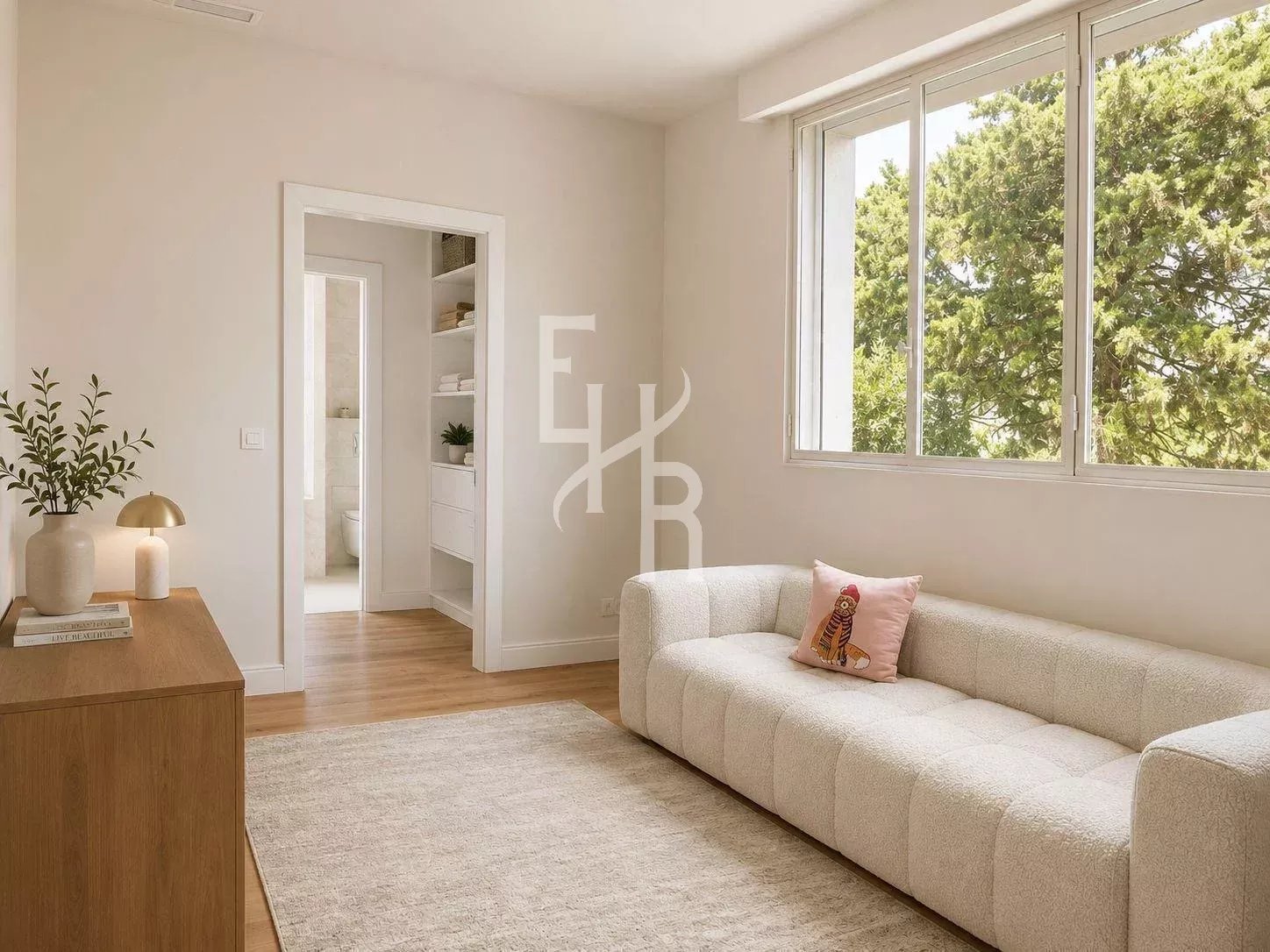 Bright living room in a renovated apartment with sofa and garden view.