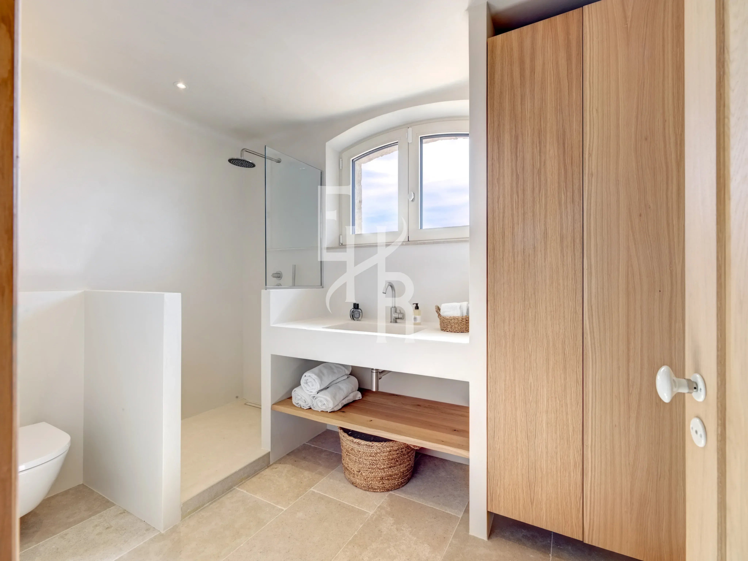 Contemporary bathroom in Mougins Modern bathroom with shower and wooden storage.