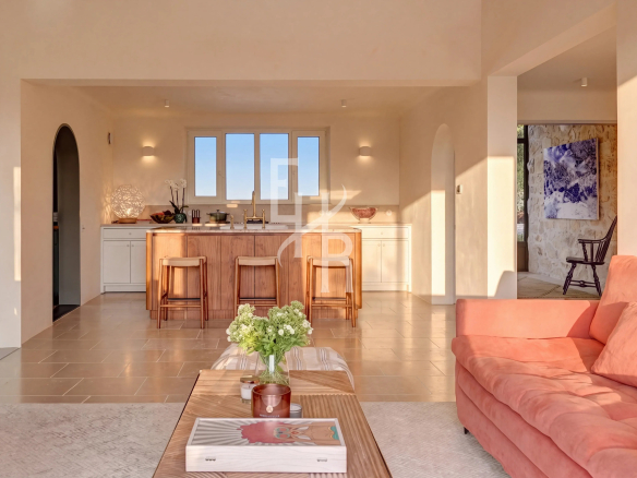 Interior of a bastide in Mougins with modern kitchen and bright living room.