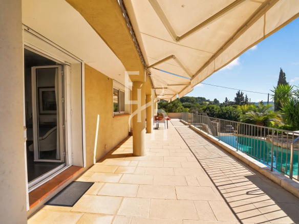 Terrasse d'une villa avec vue panoramique à Mougins, piscine et jardin.