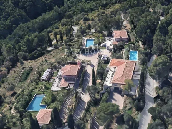 Aerial view of three luxury villas with swimming pools in Grasse, surrounded by nature.