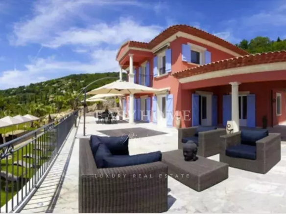 View of a luxury villa with outdoor furniture in an estate in Grasse.