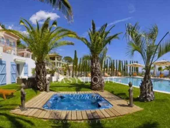 Three luxury villas with pool and garden in Grasse, surrounded by palm trees and panoramic views.