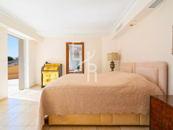 Chambre spacieuse avec lit double et accès à un balcon à Mougins.