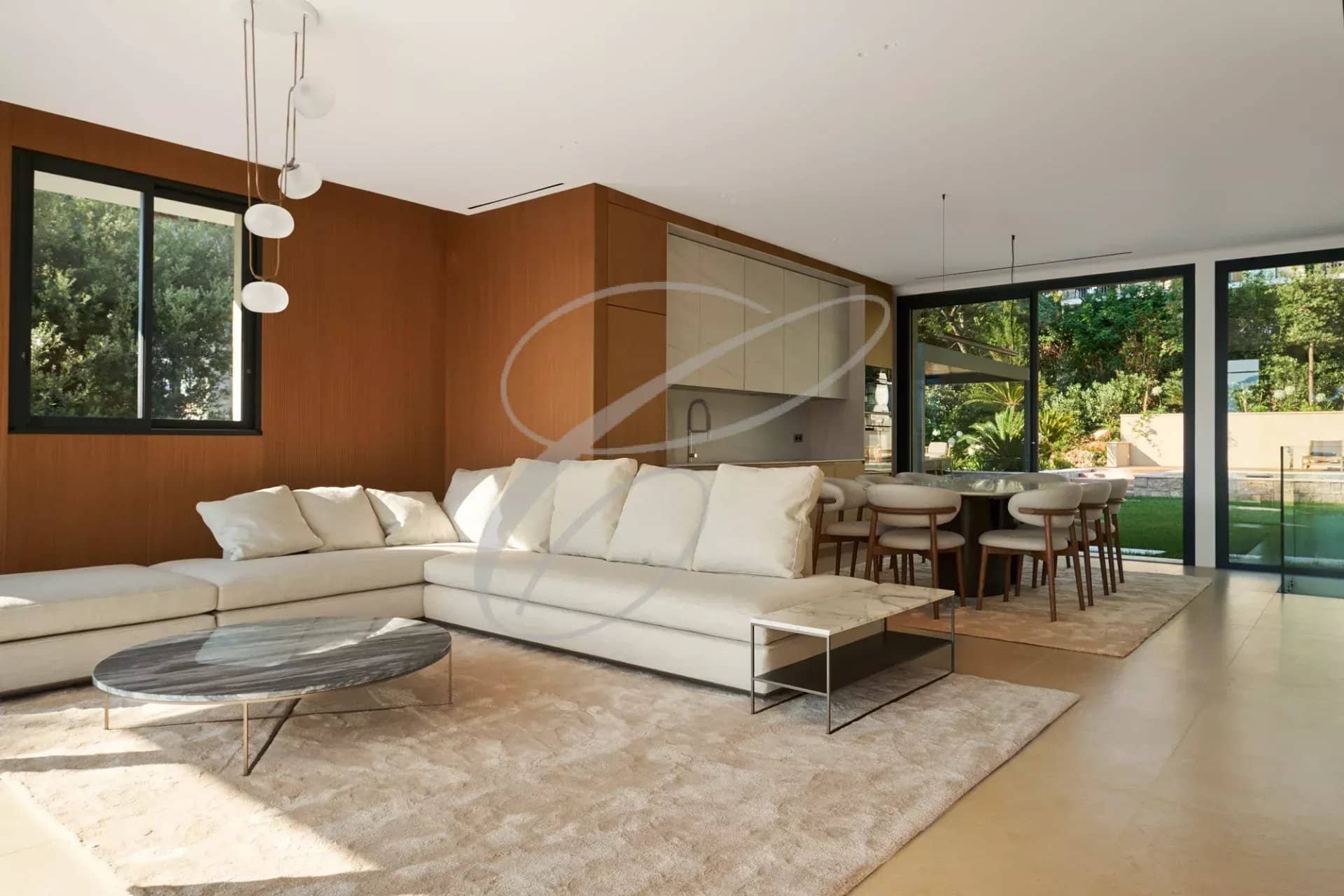 Interior of a villa in Roquebrune-Cap-Martin Interior of a luxury villa with living room and dining room, overlooking the garden and pool.