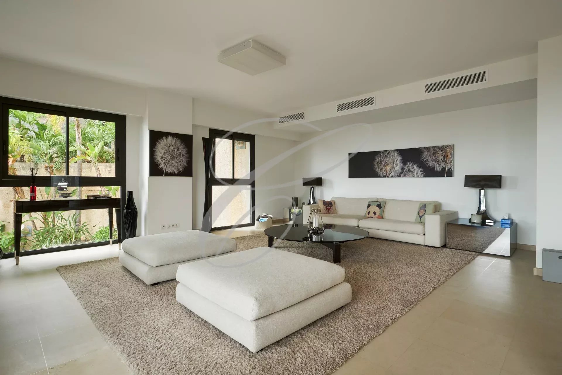 Intérieur d'une villa contemporaine avec salon spacieux et mobilier moderne.