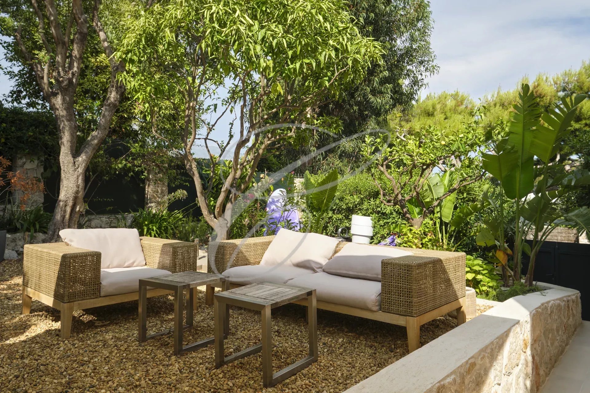Outdoor space of an apartment in Roquebrune-Cap-Martin Outdoor space of an apartment with garden furniture and lush vegetation.