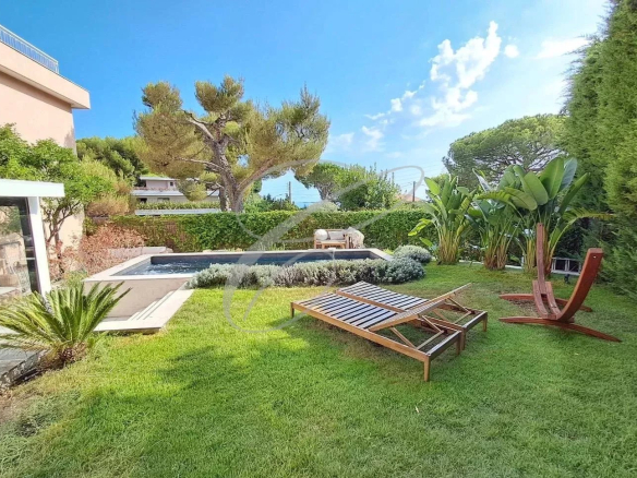 Private garden with swimming pool and sun loungers in an apartment in Roquebrune-Cap-Martin.