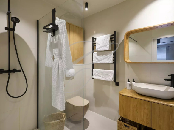 Modern shower room with walk-in shower and wooden vanity unit.