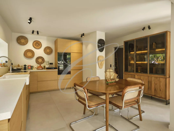 Modern kitchen with dining area in a renovated apartment.