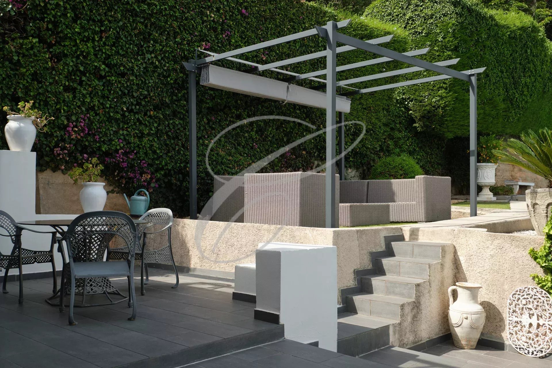 Villa terrace in Roquebrune-Cap-Martin Terrace of a villa in Roquebrune-Cap-Martin with outdoor furniture and stone staircase.