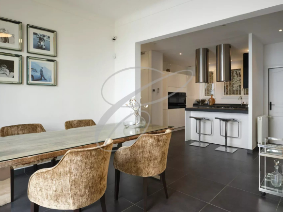 Interior of a modern villa with dining room and equipped kitchen.