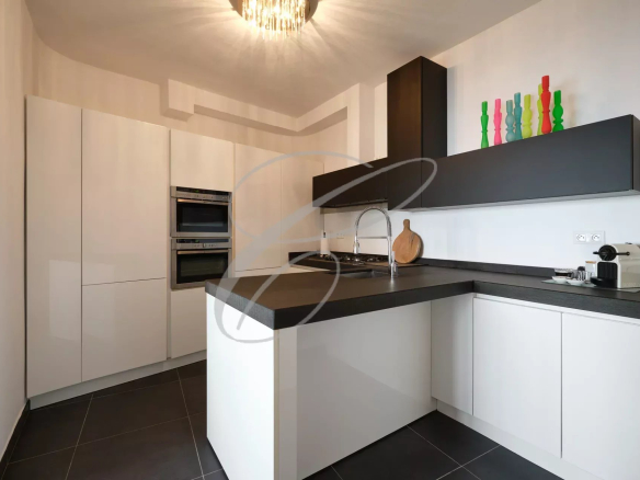 Modern kitchen with central island and integrated appliances.