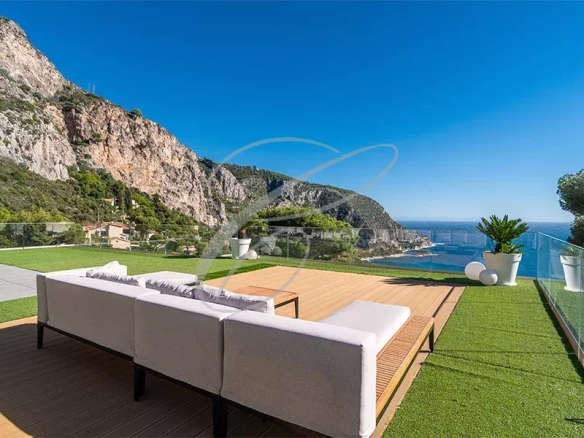 Terrasse d'une villa à Èze avec vue sur la mer et les montagnes environnantes.