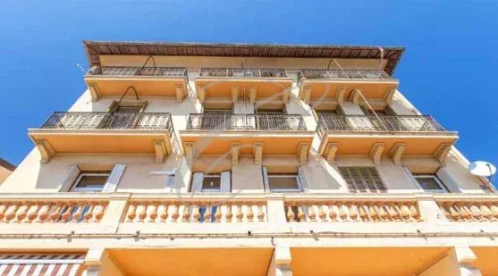Belle Époque style building in Roquebrune-Cap-Martin, overlooking the sea, with balconies and architectural details.
