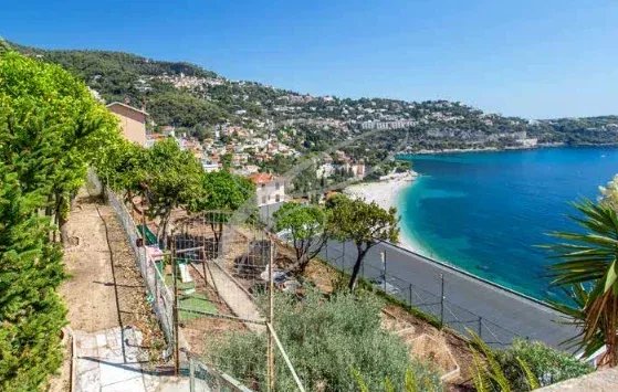 Panoramic sea view from a building to be renovated in Roquebrune-Cap-Martin, with wooded grounds and swimming pool.