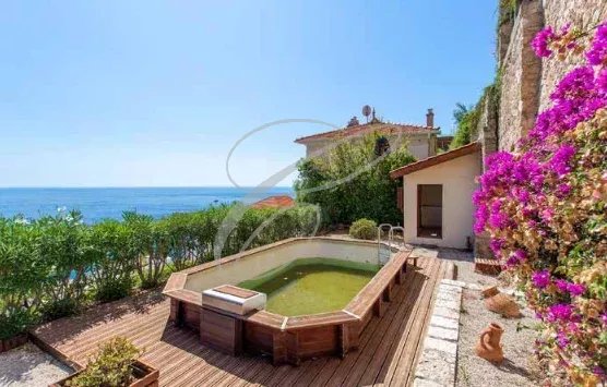 Belle Époque style building with swimming pool on wooded grounds in Roquebrune-Cap-Martin.