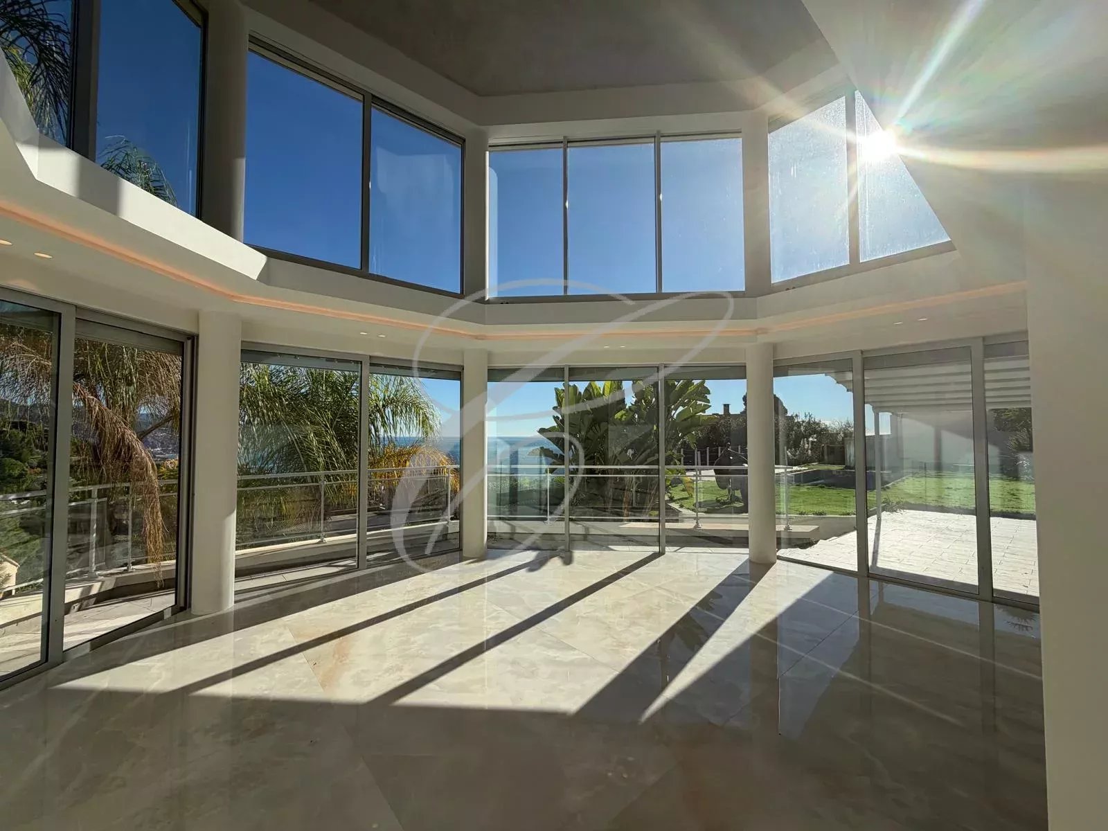 Interior of a villa in Roquebrune-Cap-Martin Spacious interior of a modern villa with large bay windows and garden views.