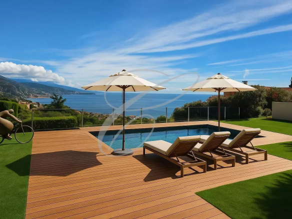 View of a modern villa with swimming pool, sun loungers and parasols, overlooking the sea in Roquebrune-Cap-Martin.