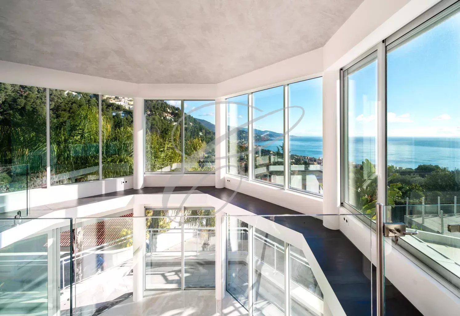 Interior of a villa in Roquebrune-Cap-Martin Interior of a modern villa with large windows offering a view of the sea.
