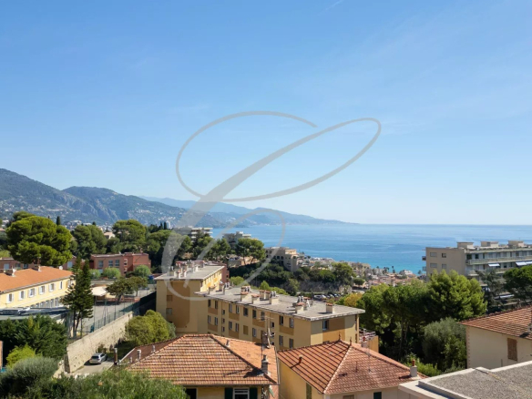 Panoramic view of the sea and the buildings of Roquebrune-Cap-Martin from a villa.