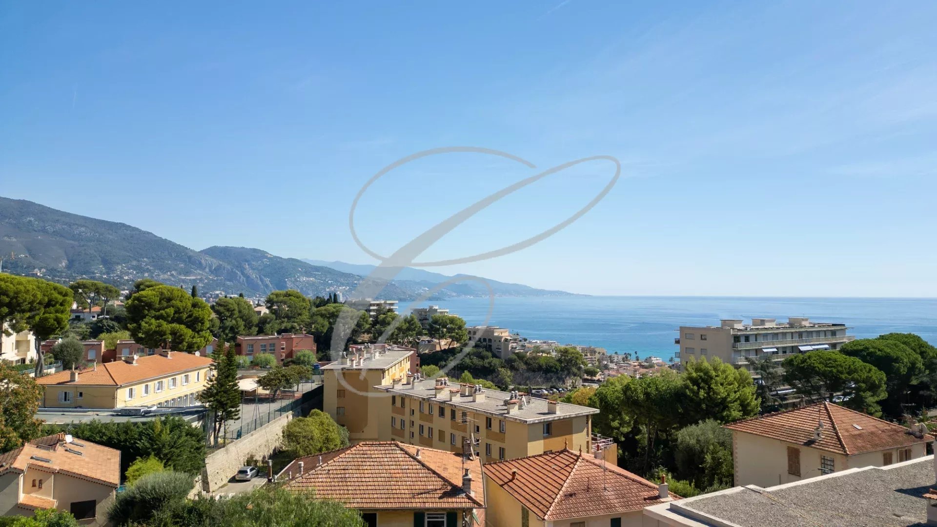 Panoramic view of the sea and the buildings of Roquebrune-Cap-Martin from a villa.