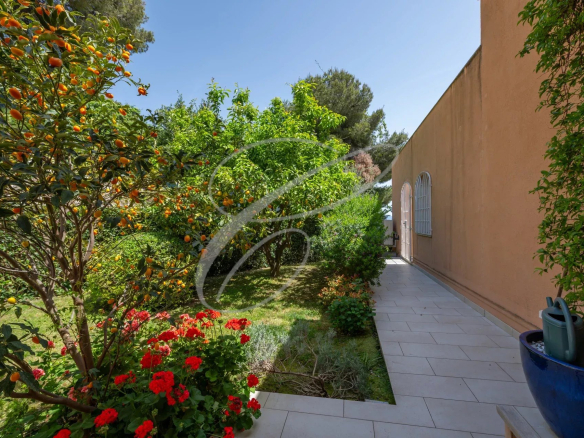 Private garden of an apartment-villa in Roquebrune-Cap-Martin with flowers and fruit trees.