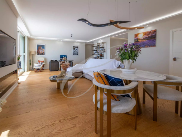 Interior of a renovated apartment-villa with a bright living room and dining area in Roquebrune-Cap-Martin.