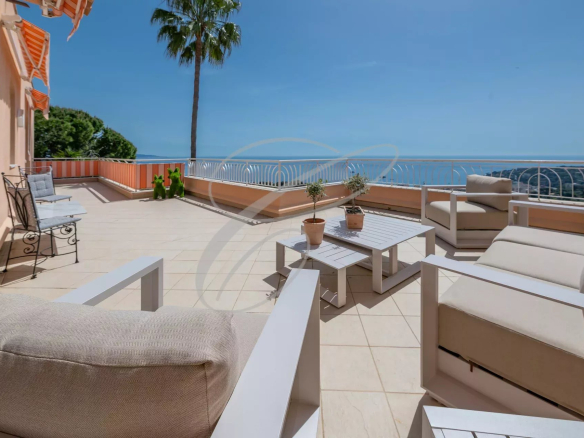 Terrace of an apartment-villa in Roquebrune-Cap-Martin with sea view and outdoor furniture.