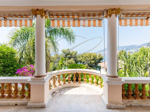 View from a terrace with columns, plants and the sea on the horizon in Roquebrune-Cap-Martin.